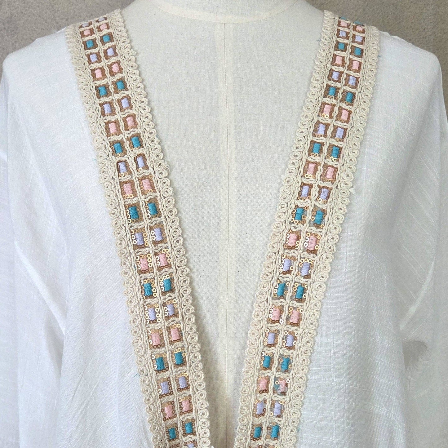 Kaftan with fluted sleeves and pastel embroidery detail and tie